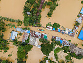 Aerial view of flooded village with submerged homes and waterlogged streets, Mirsarai, Chittagong, Bangladesh.
