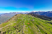 Aerial view of picturesque alpine pastures with charming chalets and cabins amidst lush meadows, Velika Planina, Kamnik, Slovenia.