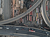 Aerial view of busy junction road and bus station with modern buildings and vibrant urban activity, Gendaria, Dhaka, Bangladesh.