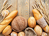 Assortment of baked bread on a white wooden background