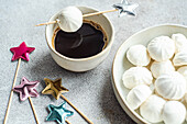 A delicious assortment of homemade vanilla mini zephyr marshmallows filled with rose jam, served with a refreshing coffee liqueur drink
