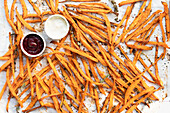 Crispy baked sweet potato sticks with spices, paired with creamy aioli and lively beetroot ketchup - a delicious snack or starter experience