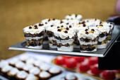 A tray of layered parfaits, beautifully arranged and ready to serve at a street party.