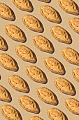 A visually appealing seamless pattern of freshly baked loaves of bread on a warm background The symmetrical arrangement creates a structured culinary design for food-themed projects
