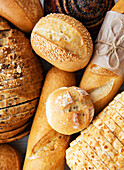 Assortment of baked bread on a white wooden background