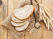 Top view of a sliced wholemeal bread on a wooden table