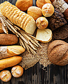 Assortment of baked bread on an old wooden background