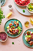 Delicious meatballs, served with fresh cucumber, pickled onions, yoghurt, pomegranate seeds and herbs on a bright blue plate. A colourful feast for the senses.