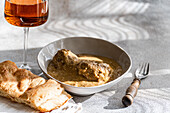 Enjoy a classic Georgian satsivi, tender chicken in a creamy walnut sauce, accompanied by amber wine and fresh Georgian bread.