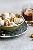 Homemade vanilla zephyr marshmallows filled with rose jam, elegantly combined with a chilled coffee liqueur drink on ice, capturing sweet indulgence and aromatic flavours