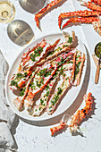 Delicious crab legs, garnished with fresh herbs and garlic, form the centrepiece of this delicious dish. Paired with white wine, this gourmet dish is both visually and flavourfully appealing
