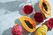 Dragon fruit, also known as pitaya, sliced pink-magenta coloured flesh with tiny black seeds, tropical fruit, long with Pspsys fruit