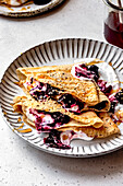 Paleo gluten-free almond flour crepes with berry compote and cream