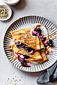 Paleo gluten-free almond flour crepes with berry compote and cream