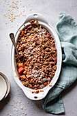Apple and rhubarb crisp in an oval baking dish