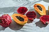 Dragon fruit, also known as pitaya, sliced pink-magenta coloured flesh with tiny black seeds, tropical fruit, long with pspsys fruit
