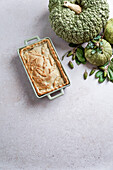 Autumn cake with pumpkin filling on unleavened dough, large green pumpkin, view from above