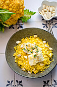 Cauliflower couscous with cod and almonds