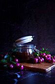 Australian Lilly-Pilly-Riberry marmalade against a black background, with negative copy space.