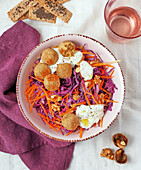 Chickpea balls with red cabbage, carrots and yoghurt dip