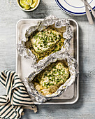 Fish fillets with herbs and rice in aluminium foil