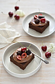 Vegan protein bean brownies with chocolate frosting and cherries