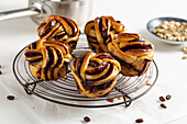 Coffee and cardamom muffins in a plait pattern