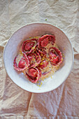 Beetroot ravioli with ricotta filling in lemon sauce
