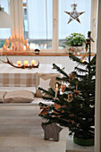 Small Christmas tree in the festively decorated dining room