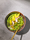 Exotic matcha rice bowl with mango and coconut chips