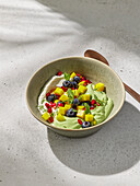 Fruit salad with green matcha cream