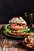 Vegan burger with deep-fried onion rings