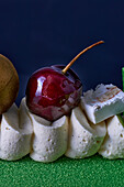 Vanilla cream bûche with cherry and nougat, close up