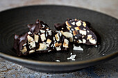 Dark chocolate almond slivers with roasted sesame seeds and sea salt