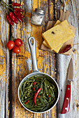 Polenta crostoni with agretti and cherry tomatoes