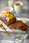 ginger loaf cake with sliced stem ginger and sugar icing, sliced.
