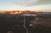 Aerial view of volcanic landscape with road cutting through valley, La Geria, Lanzarote, Canary Islands, Spain.