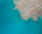 Aerial view of an abstract blue and turquoise clay lake, Art-sur-Meurthe, France.