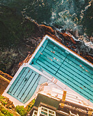 Aerial view of bondi icebergs swimming club by the ocean with waves and people enjoying the summer, Sydney, Australia.