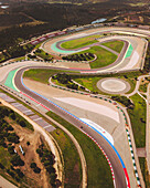 Aerial view of the modern autodromo internacional do algarve racetrack with beautiful landscape and asphalt patterns, Mexilhoeira Grande, Portugal.
