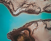 Aerial view of an abstract blue and turquoise clay lake, Art-sur-Meurthe, France.