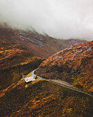Aerial view of an abstract sculpture along the road on the mountain with fog, Norway.
