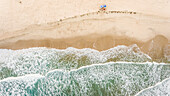 Aerial view of friends alone on the beach in Brazil.