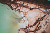 Aerial view of an abstract blue and turquoise clay lake, Art-sur-Meurthe, France.