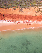 Aerial view of beautiful Bottle Bay with turquoise water and red cliffs, Francois Peron National Park, Australia.