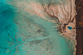 Aerial view of an abstract blue and turquoise clay lake, Art-sur-Meurthe, France.