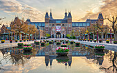 Vies of Rijksmuseum during sunrise with tulips in foreground during tulipfestival in Amsterdam, the captial of The Netherlands.