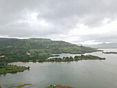 Aerial view of a camp-site by the Pawna Lake on a cloudy day in Lonavala city of Maharashtra state in India.