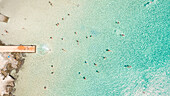 Aerial photography of people swimming in the sea of Poseidonia, Island of Syros, Greece.