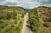 Aerial view of asphalt road in the countryside with the mountains on the horizon
